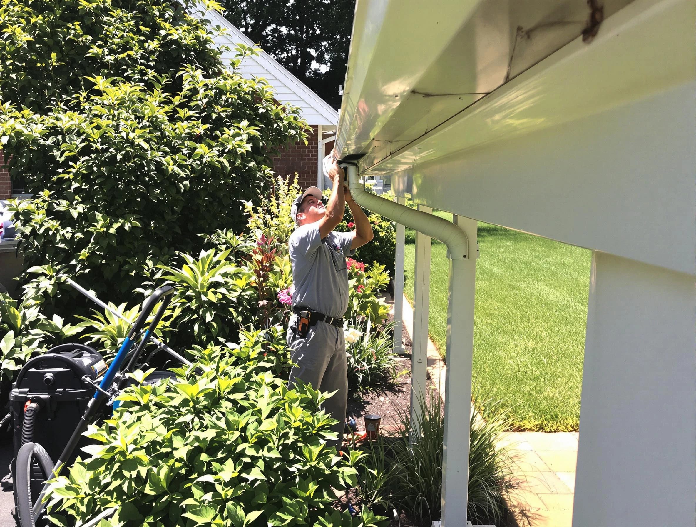 Technician flushing a blockage from a downspout in Twinsburg, OH